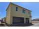 Two car garage featuring yellow siding and unfinished drywall at 2976 Embark Trail, St Cloud, FL 34771