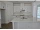 Bright kitchen featuring an island, white cabinets, and stainless steel appliances at 2976 Embark Trail, St Cloud, FL 34771