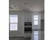 Bright kitchen featuring white cabinets, stainless steel appliances, and natural light from windows at 2976 Embark Trail, St Cloud, FL 34771