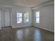 Bright living room featuring modern flooring and ample natural light with multiple windows at 2976 Embark Trail, St Cloud, FL 34771