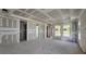 Large, unfinished living room featuring bright natural light and a high ceiling at 2976 Embark Trail, St Cloud, FL 34771