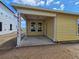 Back patio with two windows and yellow siding at 2976 Embark Trail, St Cloud, FL 34771