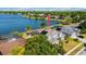 Aerial view of lakeside home featuring solar panels and beautiful lake views at 318 Osprey Lakes Cir, Chuluota, FL 32766
