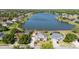 Lakefront homes featuring lush lawns, mature trees, and serene water views in a lovely neighborhood at 318 Osprey Lakes Cir, Chuluota, FL 32766