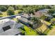 Backyard aerial showing screened in pool, lush lawn, and mature landscaping in a well-maintained neighborhood at 318 Osprey Lakes Cir, Chuluota, FL 32766