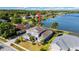 Beautiful lakefront property with lush landscaping and stunning views from an aerial perspective at 318 Osprey Lakes Cir, Chuluota, FL 32766