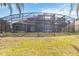 Backyard with screened enclosure at 318 Osprey Lakes Cir, Chuluota, FL 32766