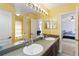 Bathroom featuring double sinks, granite counters, and access to the ensuite bedroom at 318 Osprey Lakes Cir, Chuluota, FL 32766