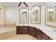 Elegant bathroom with double sinks, granite counters, and a tiled backsplash and soaking tub at 318 Osprey Lakes Cir, Chuluota, FL 32766