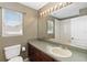 Bathroom featuring granite countertop, updated fixtures, large vanity, and natural light at 318 Osprey Lakes Cir, Chuluota, FL 32766