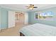 Bedroom featuring lake view, carpet, blue walls, and a walk through to the game room at 318 Osprey Lakes Cir, Chuluota, FL 32766