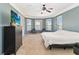 Spacious primary bedroom with views of the lake, neutral carpet, and a ceiling fan at 318 Osprey Lakes Cir, Chuluota, FL 32766