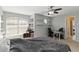 Bedroom features a ceiling fan, shelving and a large window at 318 Osprey Lakes Cir, Chuluota, FL 32766