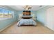 Bedroom with a large window allowing natural light and complemented by light blue walls at 318 Osprey Lakes Cir, Chuluota, FL 32766