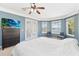 Inviting main bedroom features a door to the backyard with lake views, neutral carpet, and blue accent wall at 318 Osprey Lakes Cir, Chuluota, FL 32766