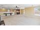 Large bonus room features neutral carpeting, wet bar, ceiling fan, and natural light at 318 Osprey Lakes Cir, Chuluota, FL 32766