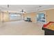 Spacious bonus room with carpet, ceiling fan, large windows, and view of the lake at 318 Osprey Lakes Cir, Chuluota, FL 32766
