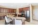 Modern kitchen with stainless appliances, custom wood cabinets, granite countertops, and a center island at 318 Osprey Lakes Cir, Chuluota, FL 32766
