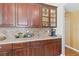 Close up of kitchen with custom wood cabinets, granite countertops, and tile backsplash details at 318 Osprey Lakes Cir, Chuluota, FL 32766
