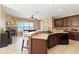 Gourmet kitchen with granite counters, a breakfast bar, and a cozy living space with lake views at 318 Osprey Lakes Cir, Chuluota, FL 32766