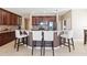 Stylish kitchen with stainless appliances, custom cabinets, granite countertops, and breakfast bar seating at 318 Osprey Lakes Cir, Chuluota, FL 32766