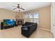 Well-lit living room with fireplace, ceiling fan, and large windows, perfect for relaxing and entertaining at 318 Osprey Lakes Cir, Chuluota, FL 32766