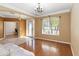 Elegant living area boasts hardwood floors, archways, and a large window for ample natural light at 318 Osprey Lakes Cir, Chuluota, FL 32766