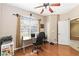 Bright office features hardwood floors, a large window, and ample space for productivity and creativity at 318 Osprey Lakes Cir, Chuluota, FL 32766