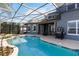 Enclosed pool features spa, outdoor kitchen and covered patio at 318 Osprey Lakes Cir, Chuluota, FL 32766