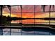Screened-in pool area showcasing a beautiful sunset over the tranquil lake at 318 Osprey Lakes Cir, Chuluota, FL 32766