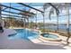 Enjoy the large screened-in pool and spa with views of the lake at 318 Osprey Lakes Cir, Chuluota, FL 32766