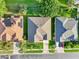 Aerial view showing a neatly maintained home with a neutral roof, green lawn, and well-kept neighboring properties at 3514 Forest Ridge Ln, Kissimmee, FL 34741