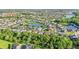Expansive aerial view showcasing a residential community with lush landscaping, serene lakes, and tree-lined streets at 3514 Forest Ridge Ln, Kissimmee, FL 34741