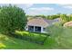 Well-maintained backyard featuring a screened lanai, lush lawn, and a secure black metal fence for privacy at 3514 Forest Ridge Ln, Kissimmee, FL 34741