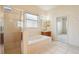 Bright bathroom featuring a soaking tub and walk in shower at 3514 Forest Ridge Ln, Kissimmee, FL 34741