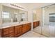 Bathroom featuring a large mirror and double sink vanity at 3514 Forest Ridge Ln, Kissimmee, FL 34741