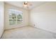 A carpeted bedroom features a large window offering abundant natural light and views at 3514 Forest Ridge Ln, Kissimmee, FL 34741