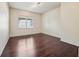 A spacious bedroom with hardwood floors and bright natural light from the window at 3514 Forest Ridge Ln, Kissimmee, FL 34741