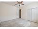 Bedroom with neutral walls, ceiling fan, closet and carpet flooring at 3514 Forest Ridge Ln, Kissimmee, FL 34741