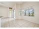 Open dining area with tile flooring, neutral walls, and large windows with a lake view at 3514 Forest Ridge Ln, Kissimmee, FL 34741