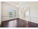 Elegant dining room with hardwood floors, arched entryway, and decorative chandelier at 3514 Forest Ridge Ln, Kissimmee, FL 34741