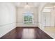 Elegant dining room with hardwood floors, arched entryway, and decorative chandelier at 3514 Forest Ridge Ln, Kissimmee, FL 34741
