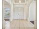Elegant foyer featuring a double-door entrance, tiled flooring, and decorative columns at 3514 Forest Ridge Ln, Kissimmee, FL 34741