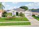 Lovely single-story home featuring a green front door and well-kept landscaping at 3514 Forest Ridge Ln, Kissimmee, FL 34741