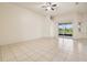 Spacious living room with tiled floors, ceiling fan, and sliding glass doors to the outside at 3514 Forest Ridge Ln, Kissimmee, FL 34741