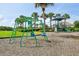 Community playground with swings and a play structure, set among palm trees, offering fun for children at 3514 Forest Ridge Ln, Kissimmee, FL 34741