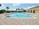 Community swimming pool with brick paver deck and a covered pavilion nearby with tables and chairs at 3514 Forest Ridge Ln, Kissimmee, FL 34741