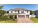 Beautiful two-story home featuring a brick driveway and well-manicured lawn at 3556 Cheswick Dr, Ocoee, FL 34761