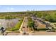 Charming townhomes line a street next to a tranquil lake, surrounded by lush greenery and distant industrial buildings at 3912 Avalon Park West Blvd, Orlando, FL 32828