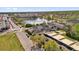 Aerial view of a mixed use community, with a pond and local shops and condos at 3912 Avalon Park West Blvd, Orlando, FL 32828
